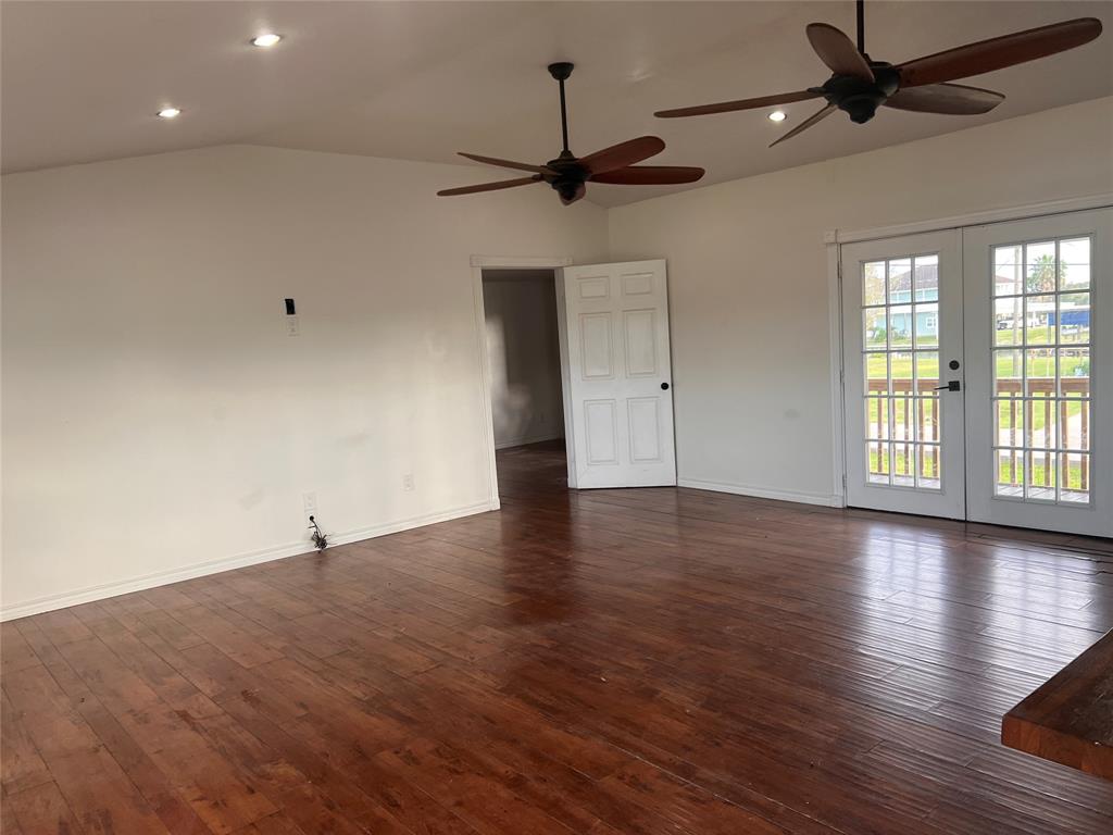 The living room with Vaulted Ceiling and Ceiling fans