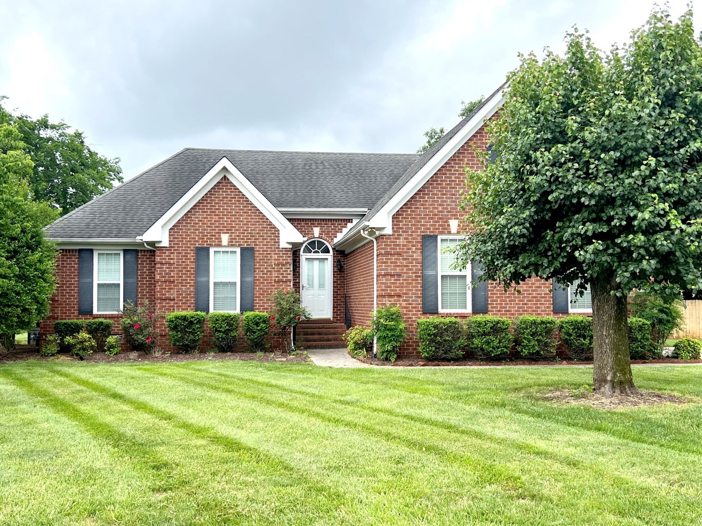 a front view of a house with garden