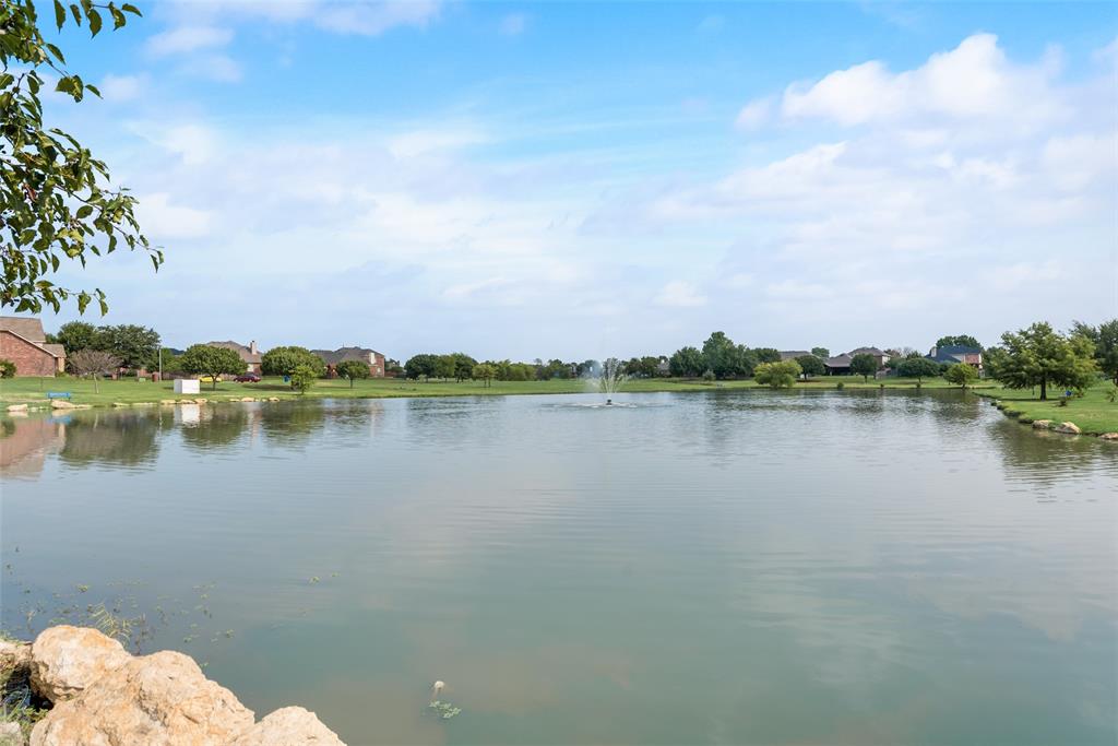 a view of a lake with houses in the back