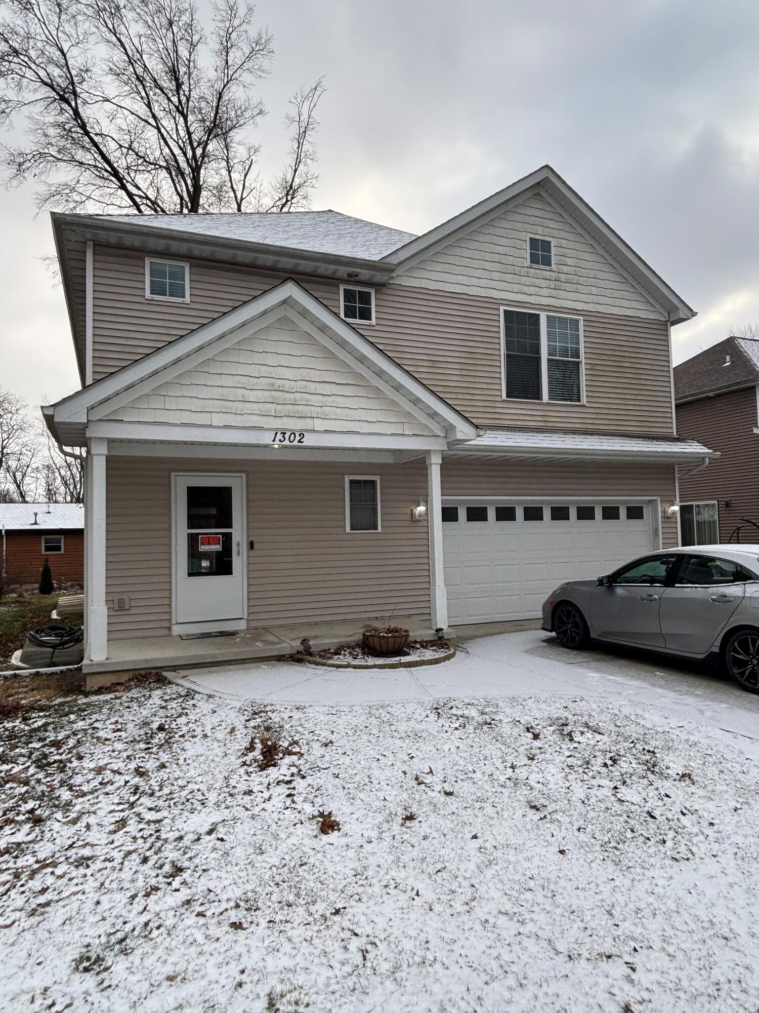 a front view of a house with parking space