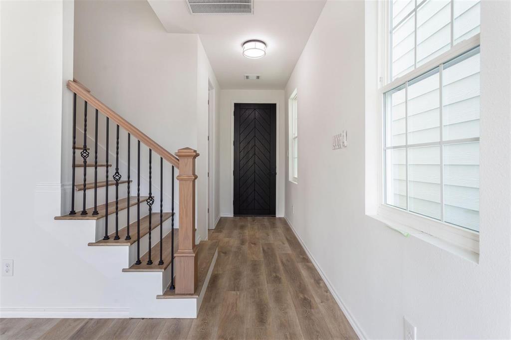 a view of a hallway with windows