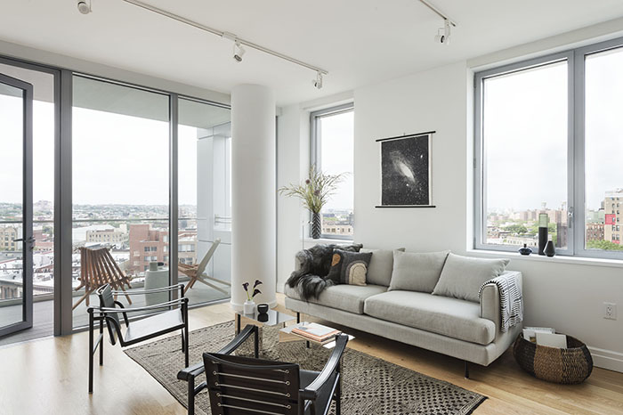 a living room with furniture and a large window