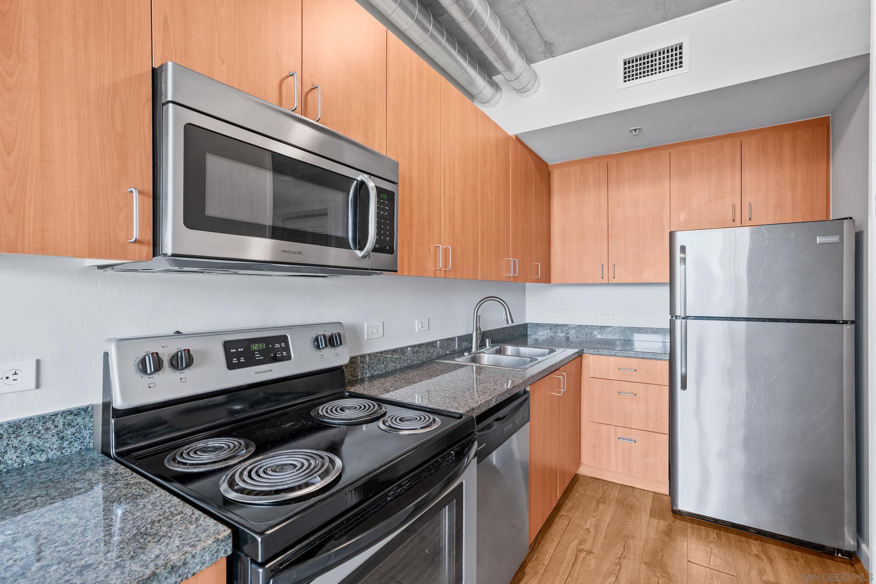 a kitchen with a stove a sink and a microwave