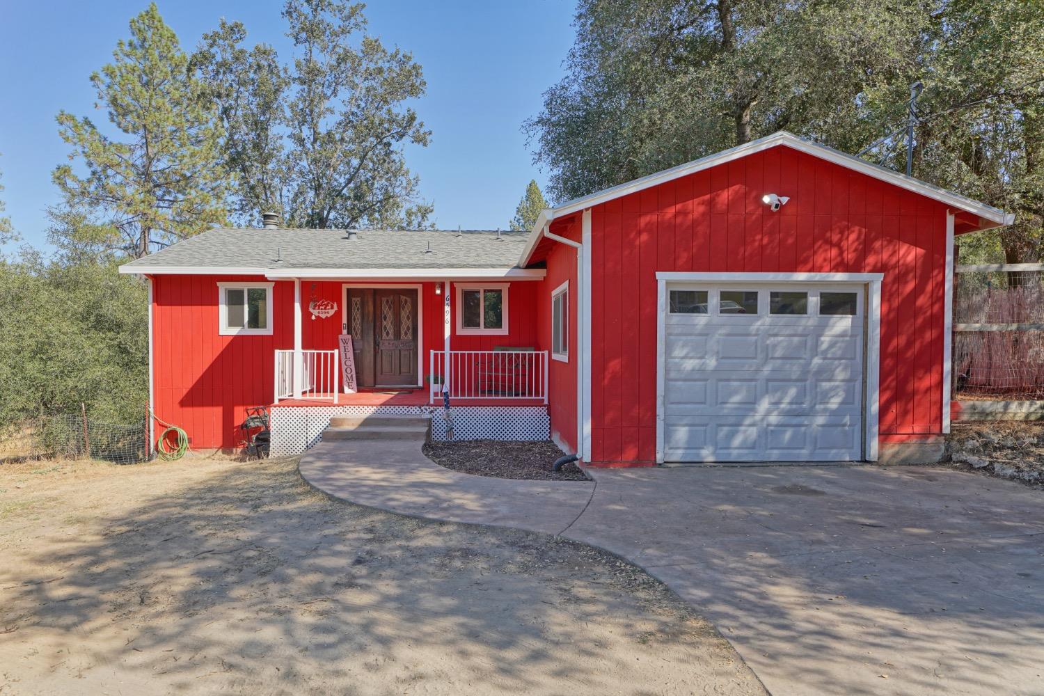 a view of a house with a yard and garage