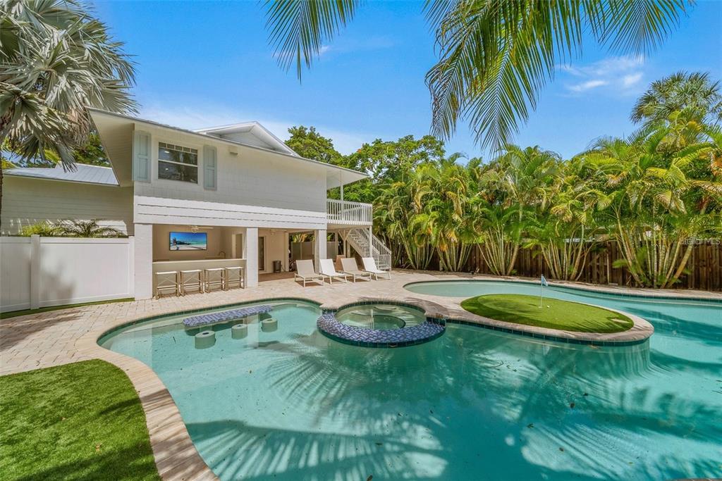 a swimming pool with outdoor seating and yard