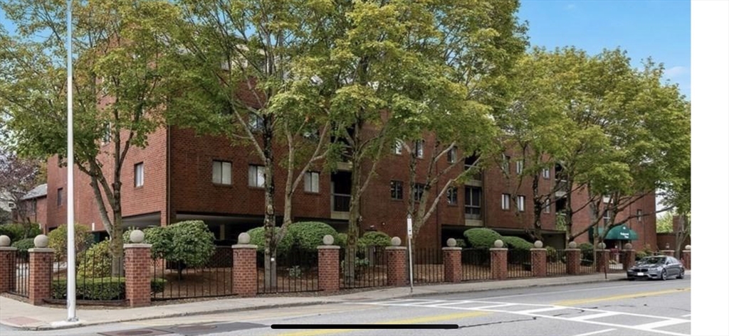 front view of a building with tree s