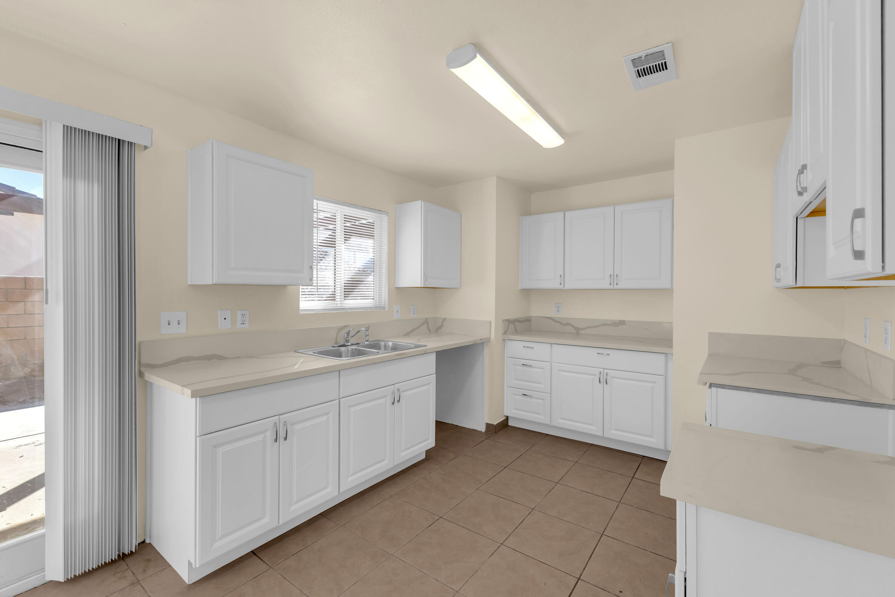 a kitchen with sink cabinets and window