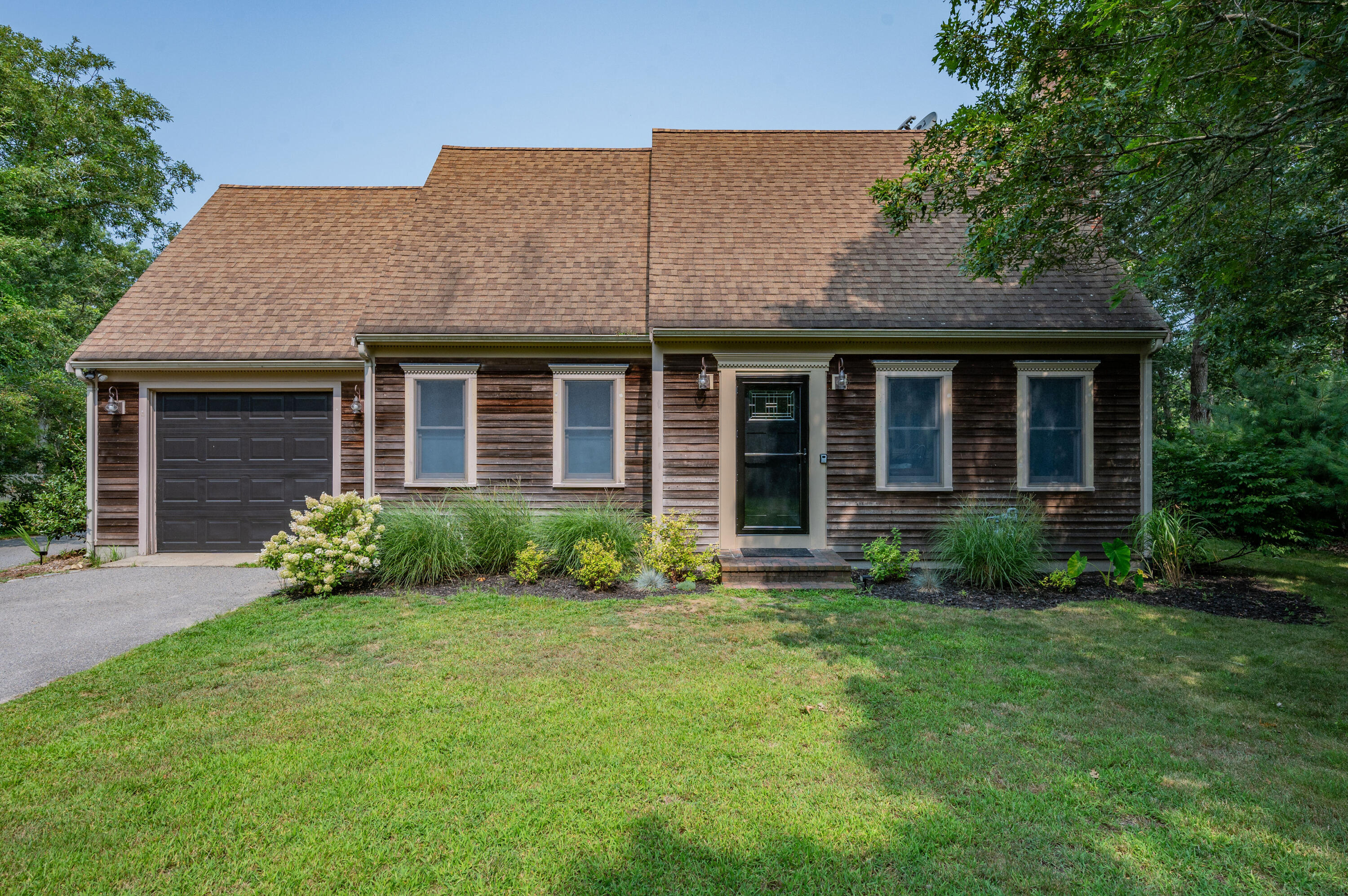 a front view of a house with garden and porch