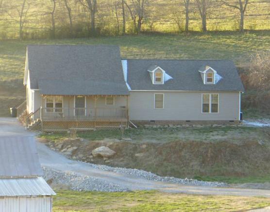 What a darling place, nestled into the hillside, with rolling hills and pasture surrounding it!